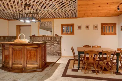 a kitchen and dining room with a table and chairs at Lakewood Cottage in Logan