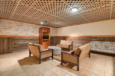 a living room with chairs and a couch and a table at Lakewood Cottage in Logan