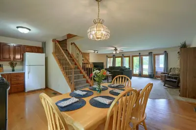 a kitchen and dining room with a table and chairs at Lakewood Cottage in Logan