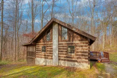 a small log cabin in the middle of a field at Shawnee in Logan