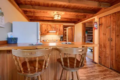a kitchen with a counter and two bar stools at Shawnee in Logan