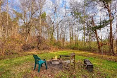 two chairs and a fire pit in the grass at Shawnee in Logan