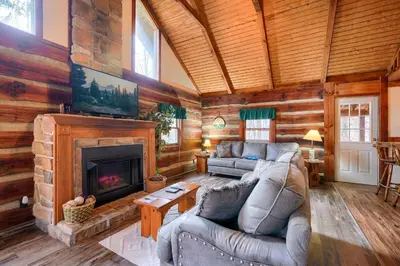 a living room with a couch and a fireplace at Shawnee in Logan