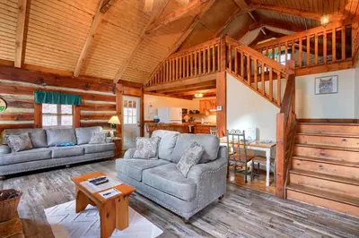 a living room with a couch and a table at Shawnee in Logan
