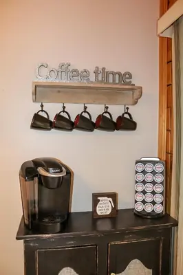 a coffee time sign on a shelf above a table at Dewdrop Inn in Logan