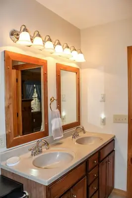 a bathroom with two sinks and a mirror at Dewdrop Inn in Logan