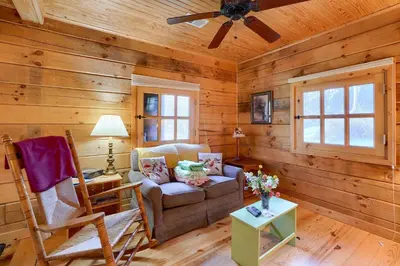a living room with a couch and a ceiling fan at Bison Hollow Hideaway in South Bloomingville