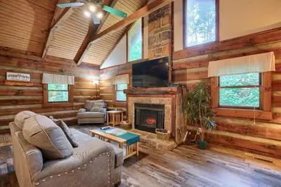 a living room with a couch and a fireplace at Cherokee in Logan