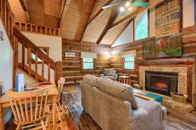 a living room with a couch and a fireplace at Cherokee in Logan