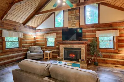 a living room with a couch and a fireplace at Cherokee in Logan