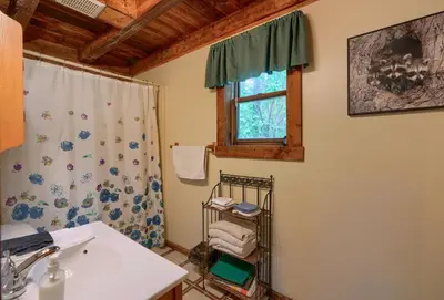 a bathroom with a sink and a window at Cherokee in Logan