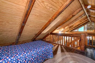 a bed in a room with a wooden ceiling at Cherokee in Logan