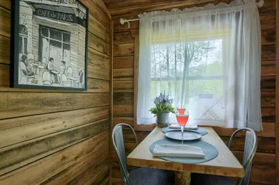 a dining room with a table and a window at Cypres Caban in Logan