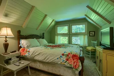 a bedroom with a bed and a television at Mercer House in Sugar Grove