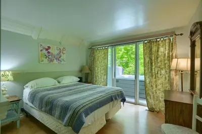 a bedroom with a bed and a large window at Mercer House in Sugar Grove