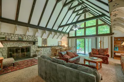 a large living room with a stone fireplace at Mercer House in Sugar Grove