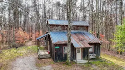 an old cabin in the middle of a forest at Navajo in Logan