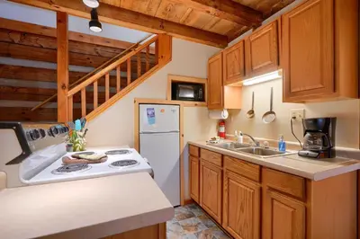 a kitchen with wooden cabinets and a white refrigerator at Navajo in Logan