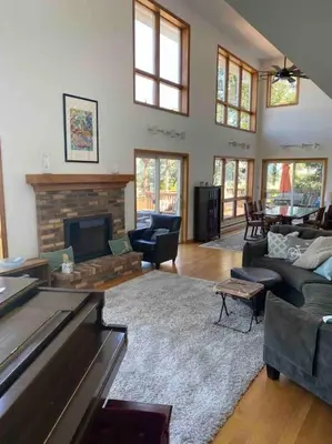 a living room filled with furniture and a fireplace at Lakeside resort home. Sunsets, fishing, paddling. in Avon Lake