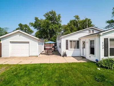 a white house with a patio and a yard at Family Fun: Comfy Home, 10 Min to Cedar Point Fun! in Huron