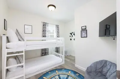 a room with two bunk beds and a couch at Port Clinton Getaway Near the Beach in Port Clinton