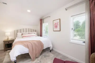 a white bedroom with a bed and a window at Port Clinton Getaway Near the Beach in Port Clinton