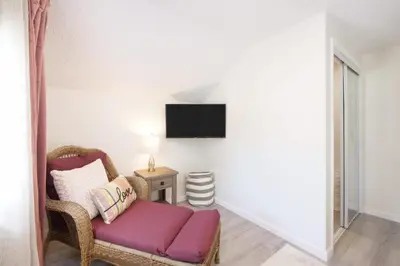 a living room with a couch and a tv on a wall at Port Clinton Getaway Near the Beach in Port Clinton