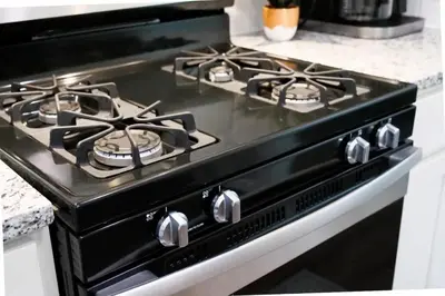 a black stove top oven in a kitchen at Modern 3BR home next to park, office space, & more in University Heights