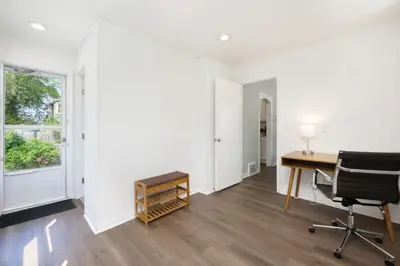 an office with a desk and a chair and a window at Modern 3BR home next to park, office space, & more in University Heights