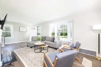 a living room with a couch and a table at Modern 3BR home next to park, office space, & more in University Heights