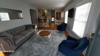 a living room with a couch and chairs and a table at The Meeker House (Charming 3/4 Bedroom Home) in Bowling Green