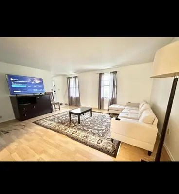 a living room with a white couch and a flat screen tv at Home in Hudson in Hudson