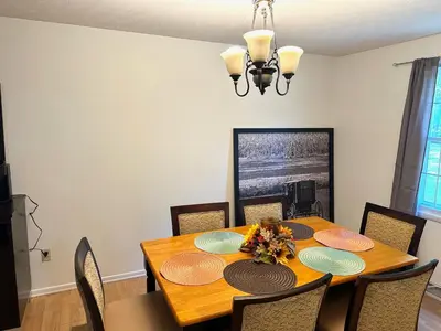 a dining room with a wooden table and chairs at Home in Hudson in Hudson