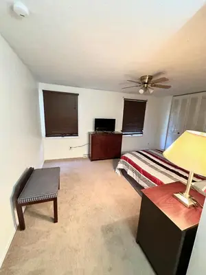 a bedroom with a bed and a table with a lamp at Home in Hudson in Hudson