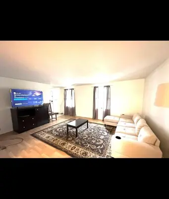 a living room with a couch and a flat screen tv at Home in Hudson in Hudson