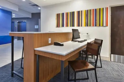 an office with a desk with a computer on it at Holiday Inn Express & Suites - Milan - Sandusky Area by IHG in Milan