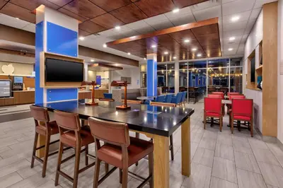 a dining room with a large table and chairs at Holiday Inn Express & Suites - Milan - Sandusky Area by IHG in Milan
