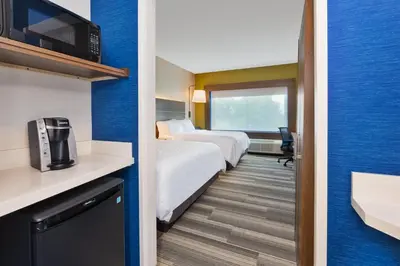a hotel room with two beds and a tv at Holiday Inn Express & Suites - Milan - Sandusky Area by IHG in Milan