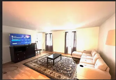 a living room with a couch and a flat screen tv at Home in Hudson in Hudson