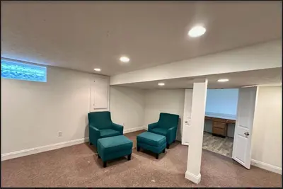 a room with two green chairs and a table at Home in Hudson in Hudson