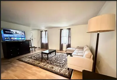 a living room with a couch and a flat screen tv at Home in Hudson in Hudson