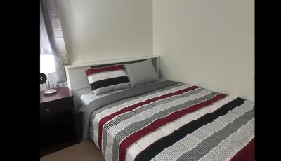 a small bedroom with a bed and a night stand at Home in Hudson in Hudson
