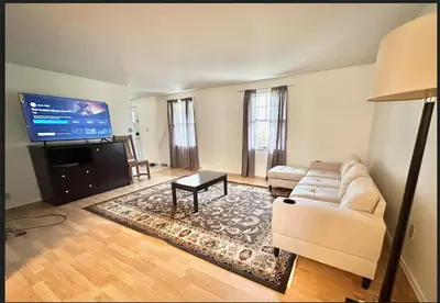 a living room with a couch and a flat screen tv at Home in Hudson in Hudson