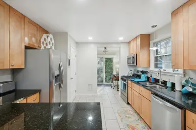 a kitchen with wooden cabinets and a stainless steel refrigerator at Exclusive Ottawa Hills Private Home, Garage, WD, Gourmet Equipped kitchen, Netflix in Ottawa Hills