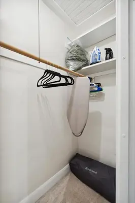 a room with a closet with a shelf and shoes at Exclusive Ottawa Hills Private Home, Garage, WD, Gourmet Equipped kitchen, Netflix in Ottawa Hills