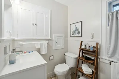 a white bathroom with a toilet and a sink at Exclusive Ottawa Hills Private Home, Garage, WD, Gourmet Equipped kitchen, Netflix in Ottawa Hills