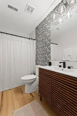 a bathroom with a sink and a toilet and a mirror at The Luxe/HotTub/Playground/12min KHP/30min Ark in Georgetown