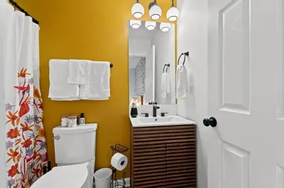 a bathroom with a toilet and a sink and a mirror at The Luxe/HotTub/Playground/12min KHP/30min Ark in Georgetown
