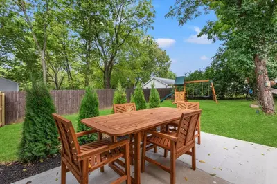 a wooden table with two chairs and a playground at The Luxe/HotTub/Playground/12min KHP/30min Ark in Georgetown