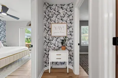 a bedroom with a bed and a white table at The Luxe/HotTub/Playground/12min KHP/30min Ark in Georgetown